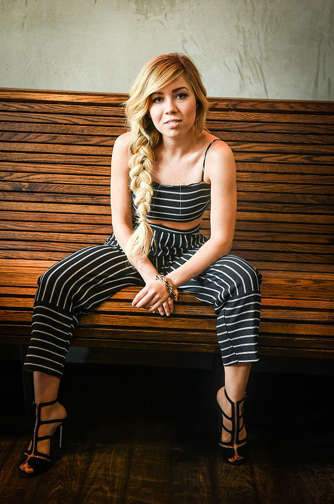 Jennette sitting on a bench for a photo shoot