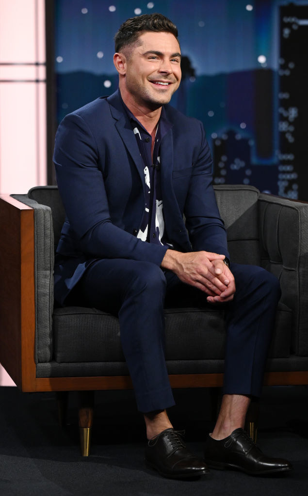 Zac on a talk show and wearing a pantsuit with no socks