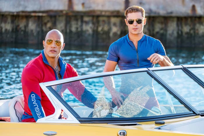 Zac and Dwayne Johnson in a boat in a scene from the film