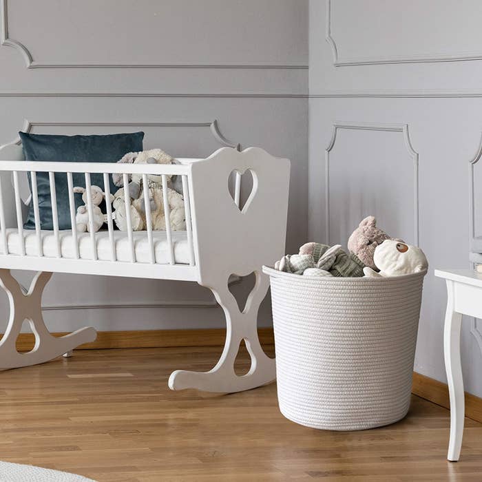 the rope basket in a nursery holding toys
