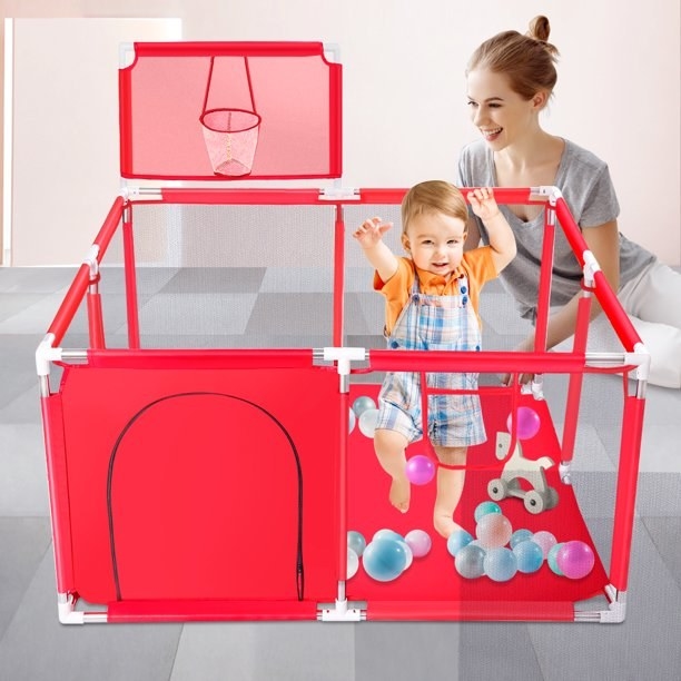 The red playpen with a basketball hoop
