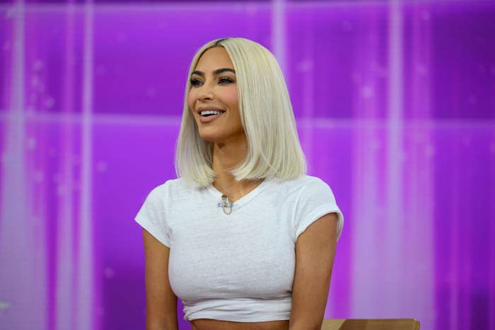 Kim smiling with blond hair and a short-sleeved top