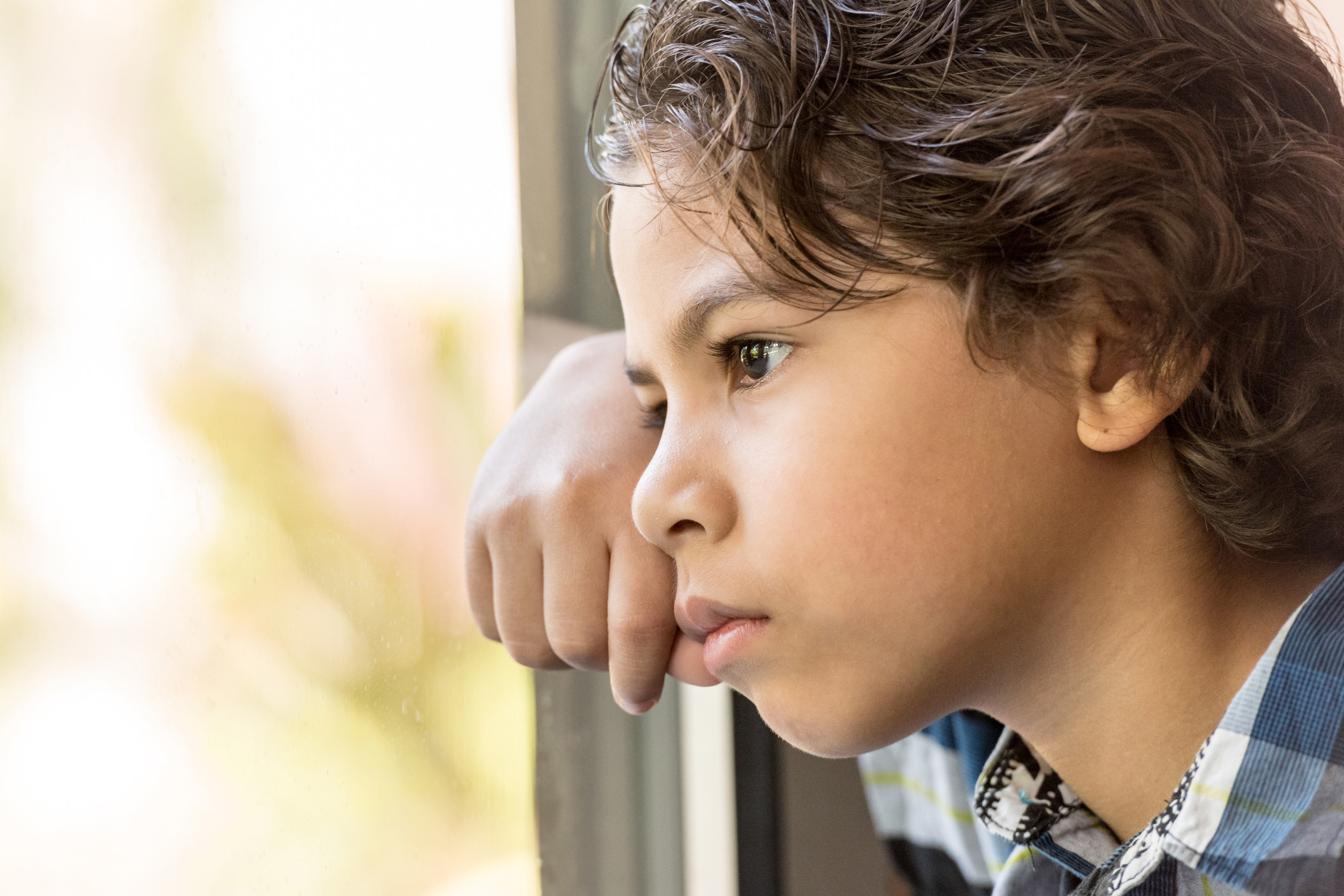 boy looking out window