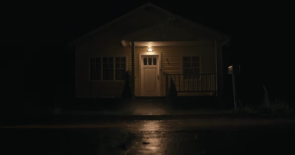 The exterior of the airbnb at night only lit by a light over the front door