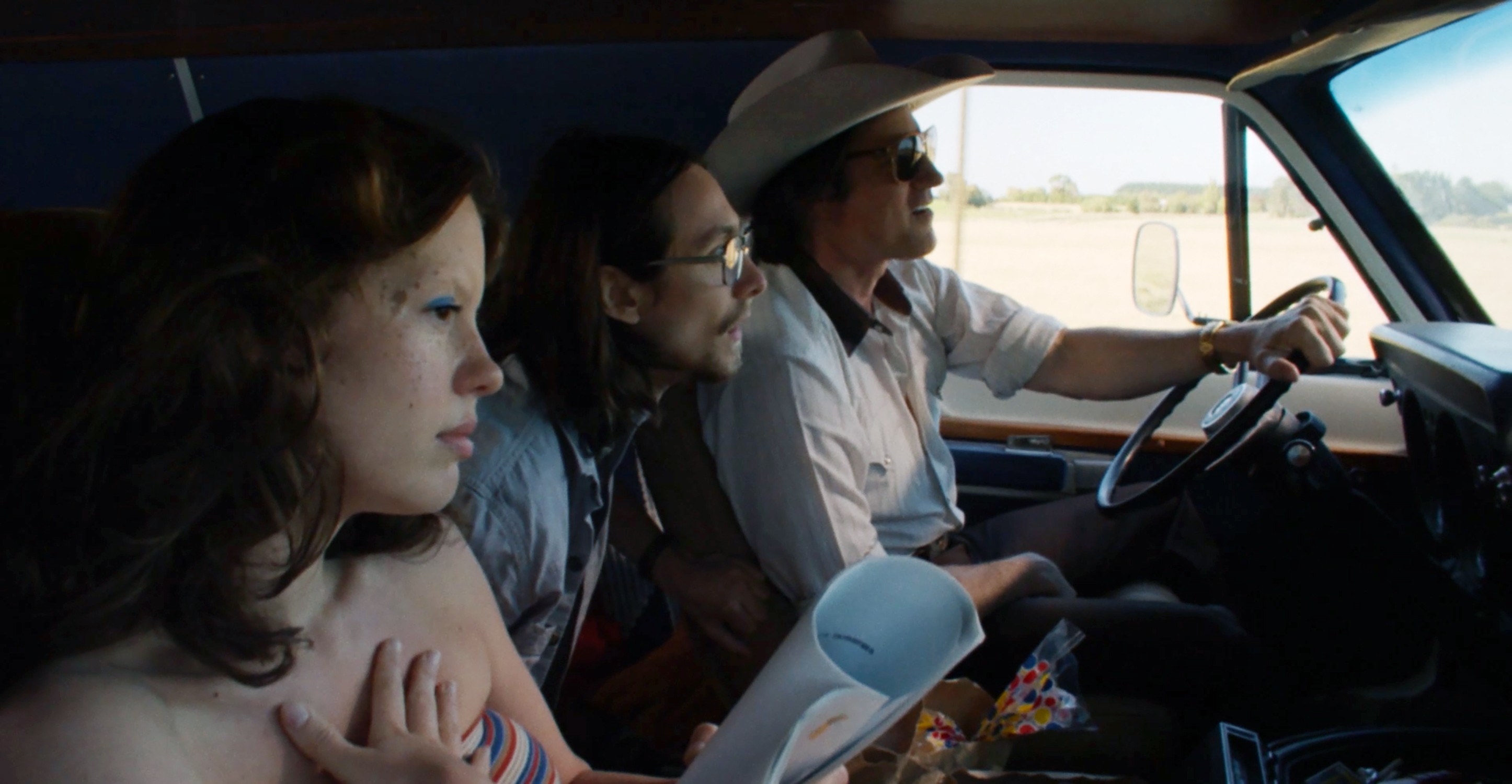 Mia Goth, Owen Campbell, Martin Henderson riding in an old pickup truck