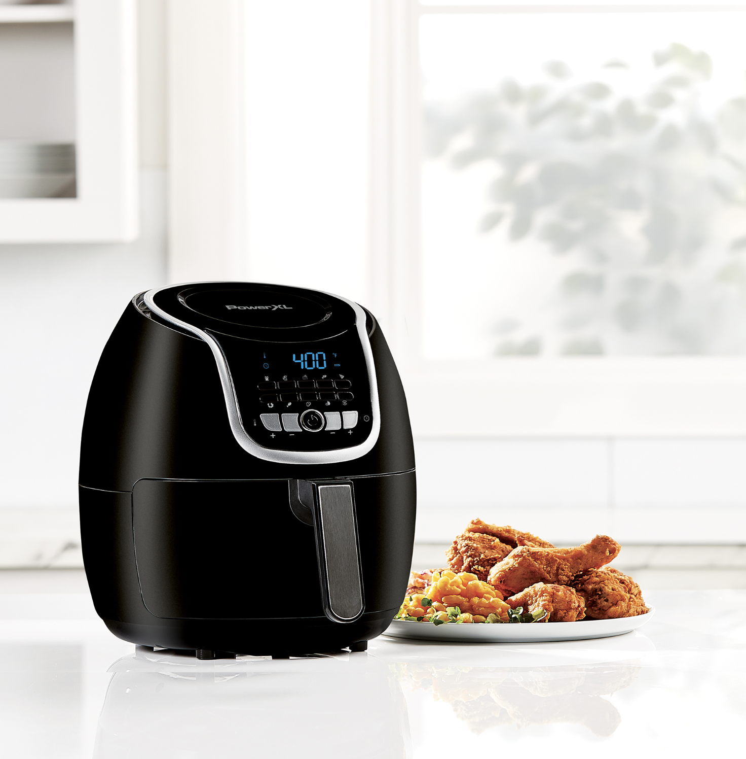 The black air fryer has a silver handle and LED display with various buttons