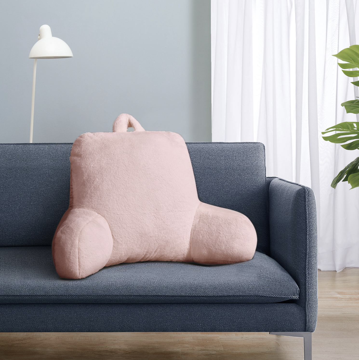 the pink bedrest pillow on a couch