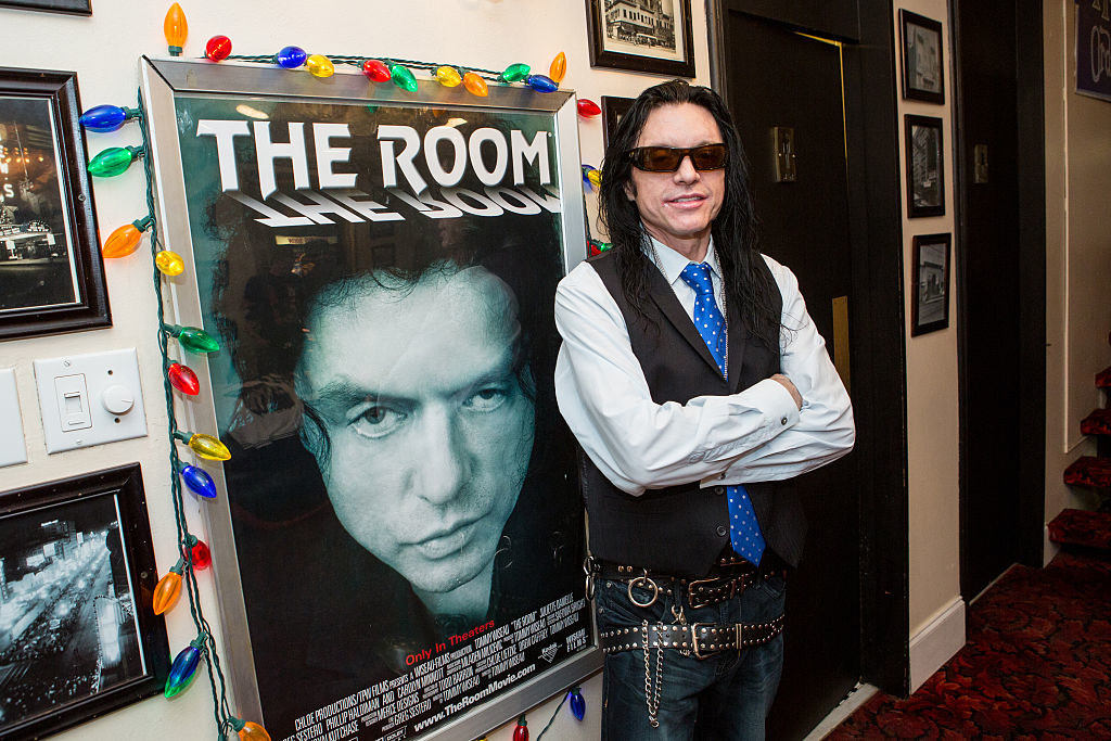 Tommy Wiseau standing in front of the room movie poster