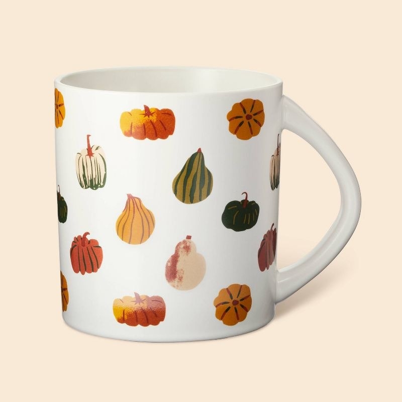 the white mug with gourds on it