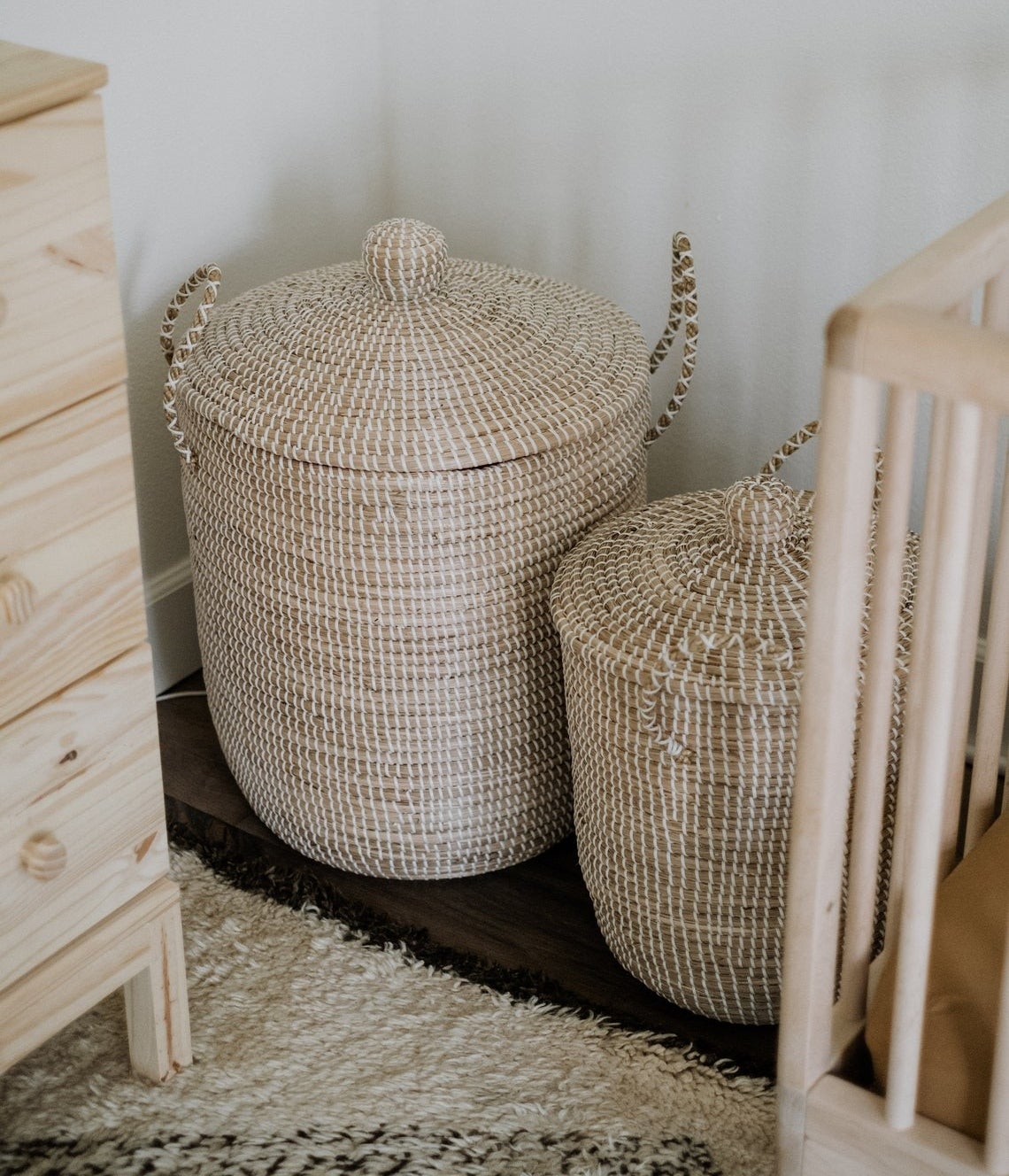 Medium and large white and light brown woven vertical baskets with handles and lids