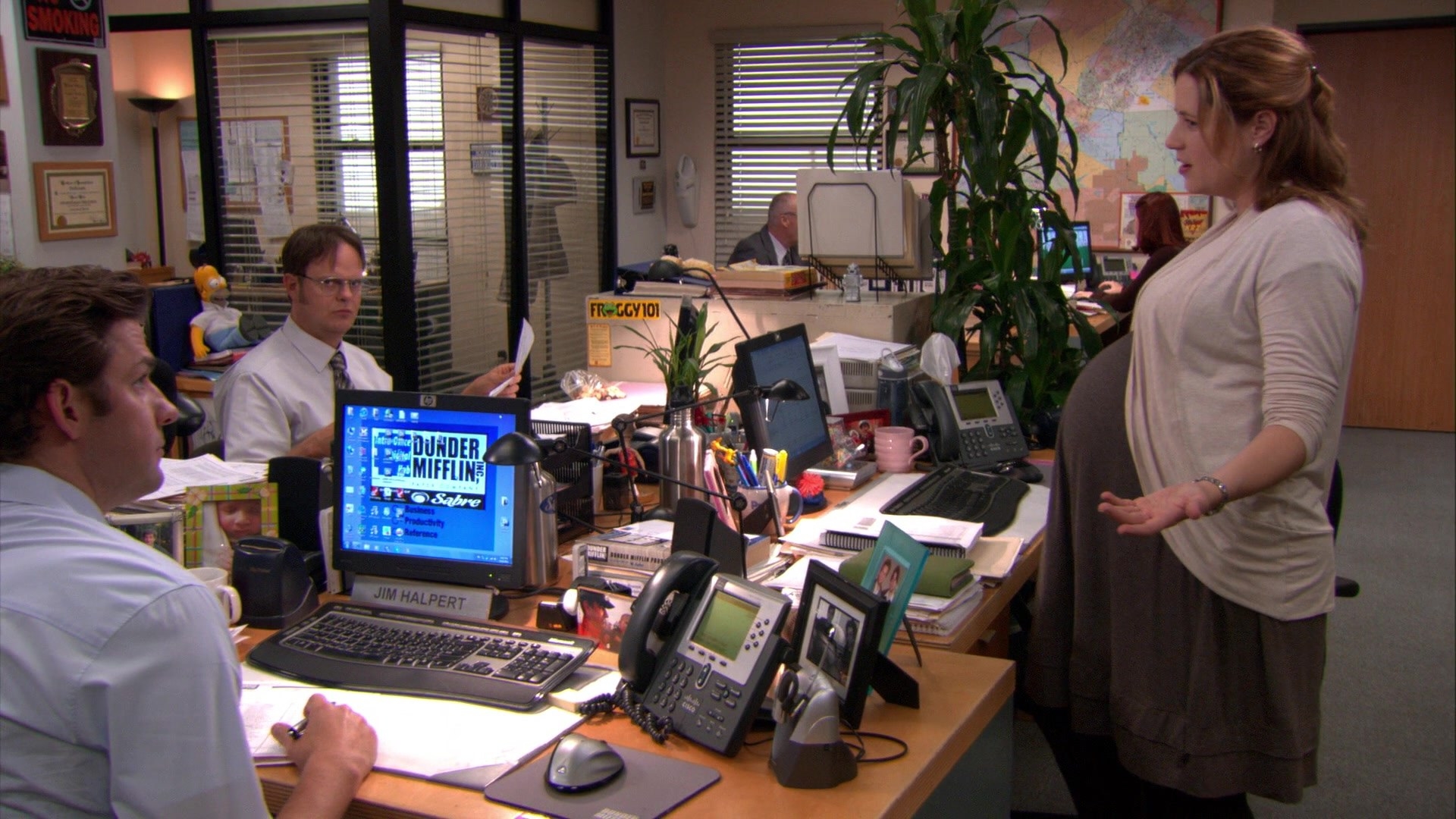 a pregnant pam standing in front of the office