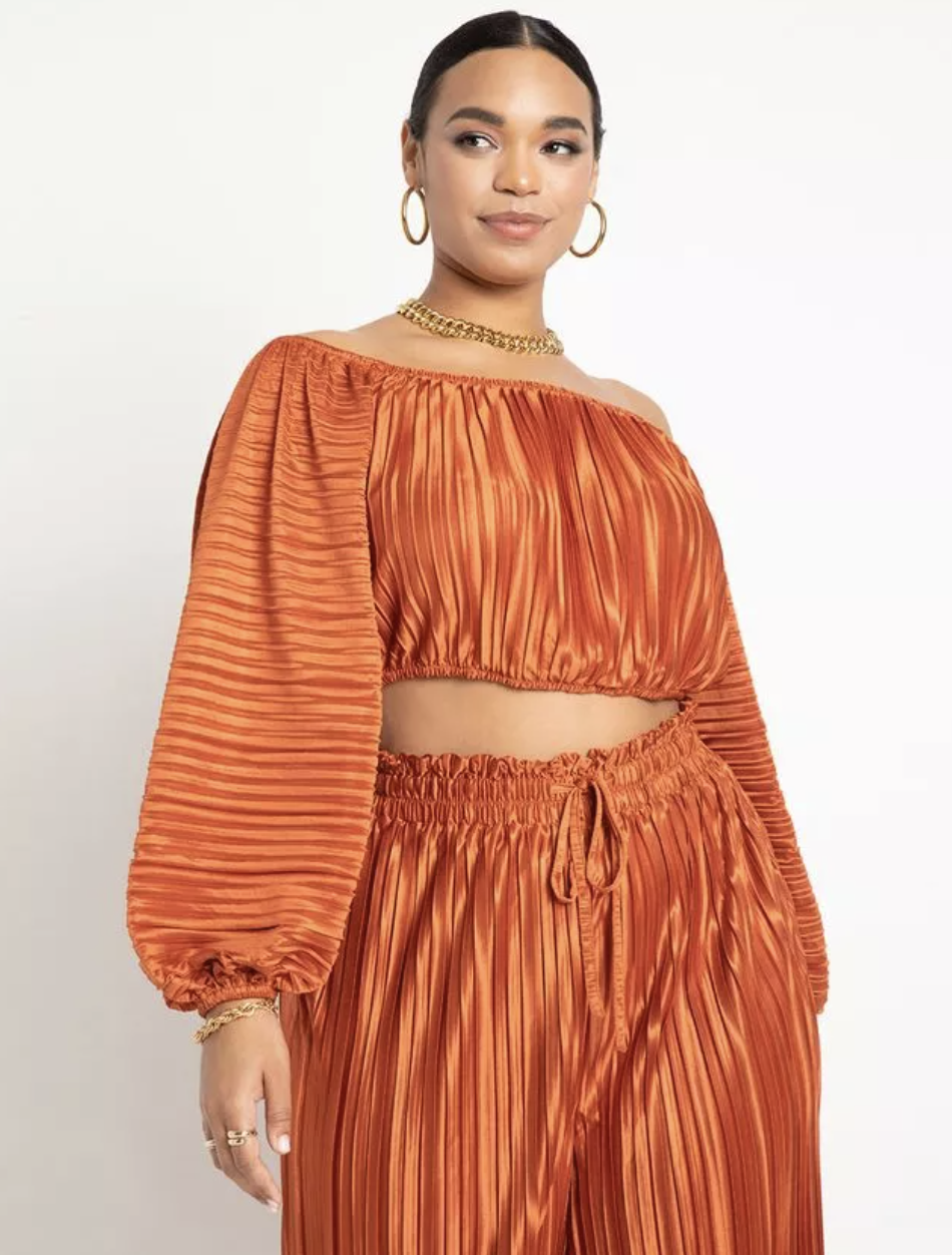 model wearing off the shoulder plisse top in an orange hue with matching pants
