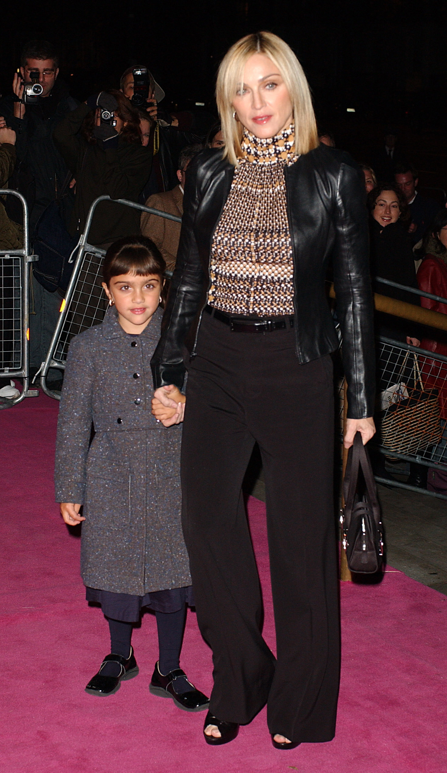 young lourdes holding her moms hand on the red carpet