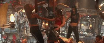 The cast of Coyote Ugly dance on the bar with water