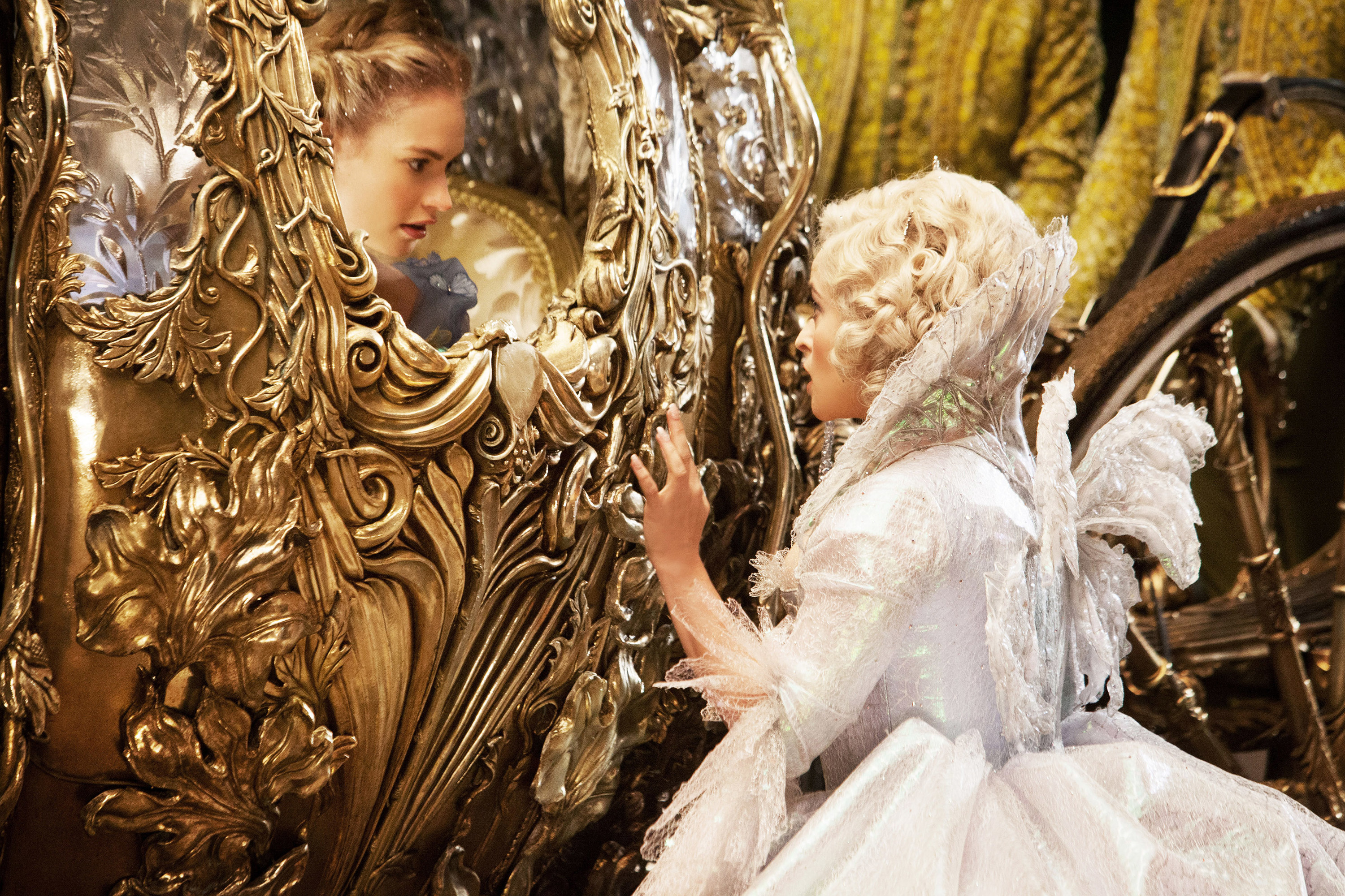 Lily James in a carriage looking at Helena Bonham Carter.