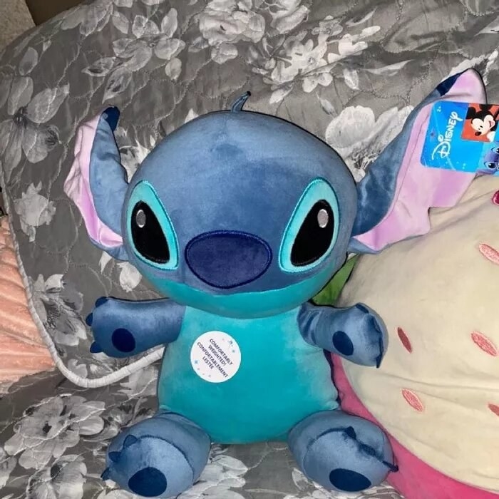 A reviewer&#x27;s plush toy of Stitch from the movie Lilo and Stitch
