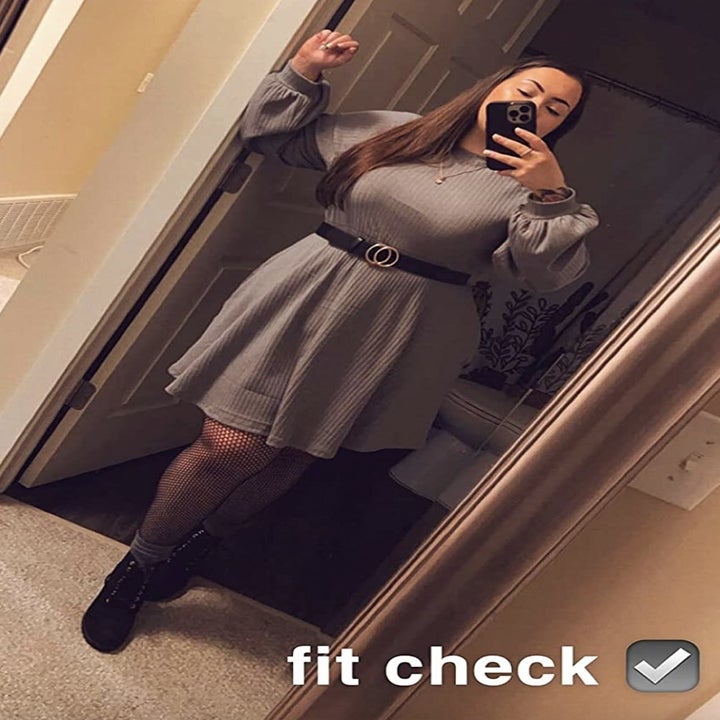 reviewer wearing the grey dress