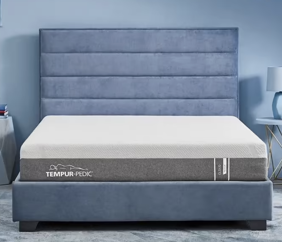 tempur-cloud compressed mattress on a blue upholstered bed frame