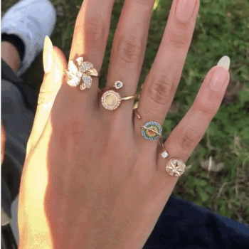 A gif of a reviewer wearing 5 of the fidget rings and demonstrating how they spin