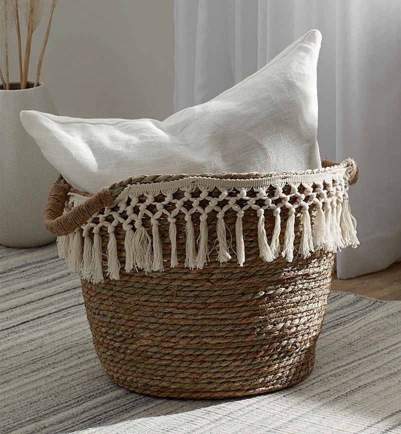 The basket on the floor holding a pillow