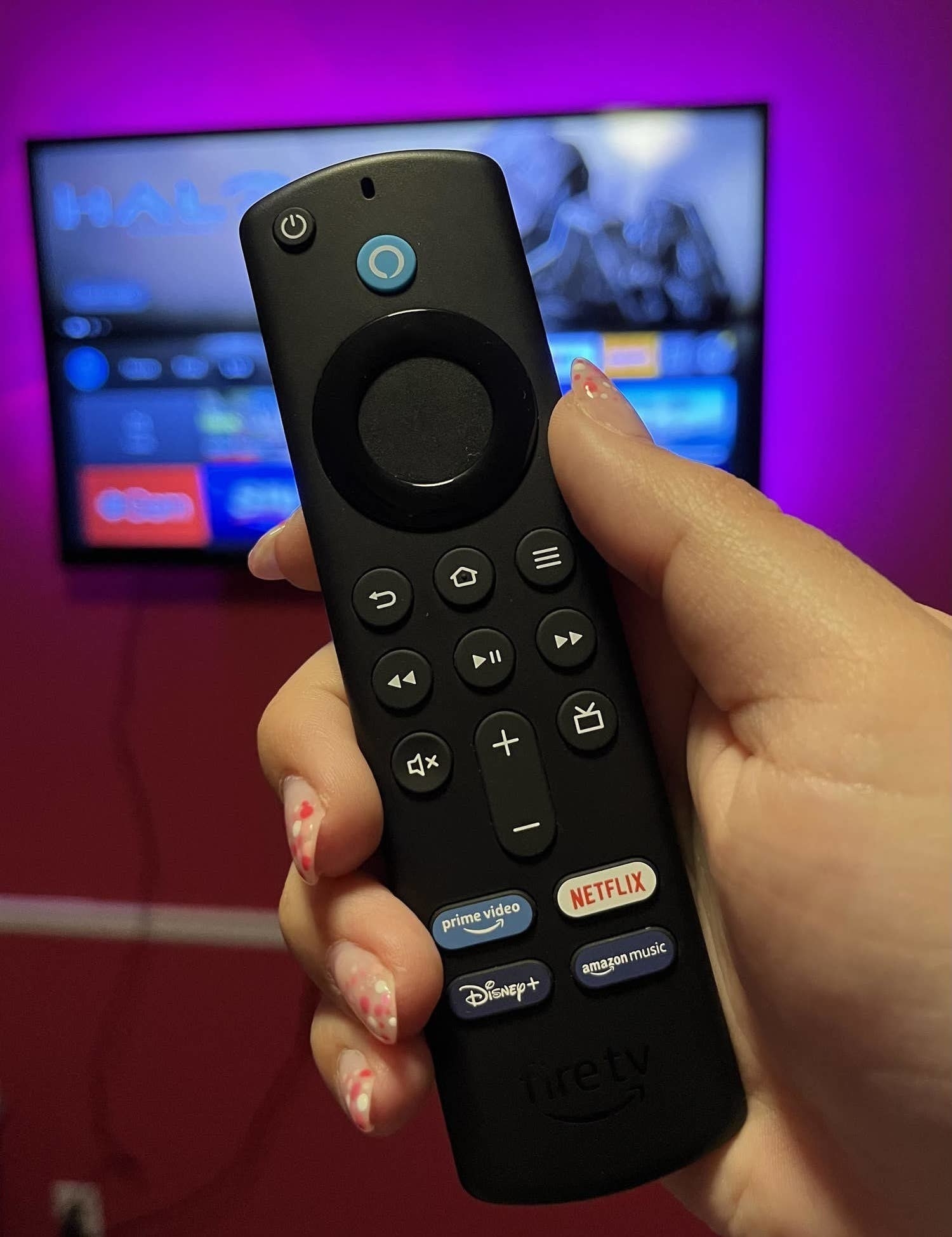 a person holding the fire tv stick
