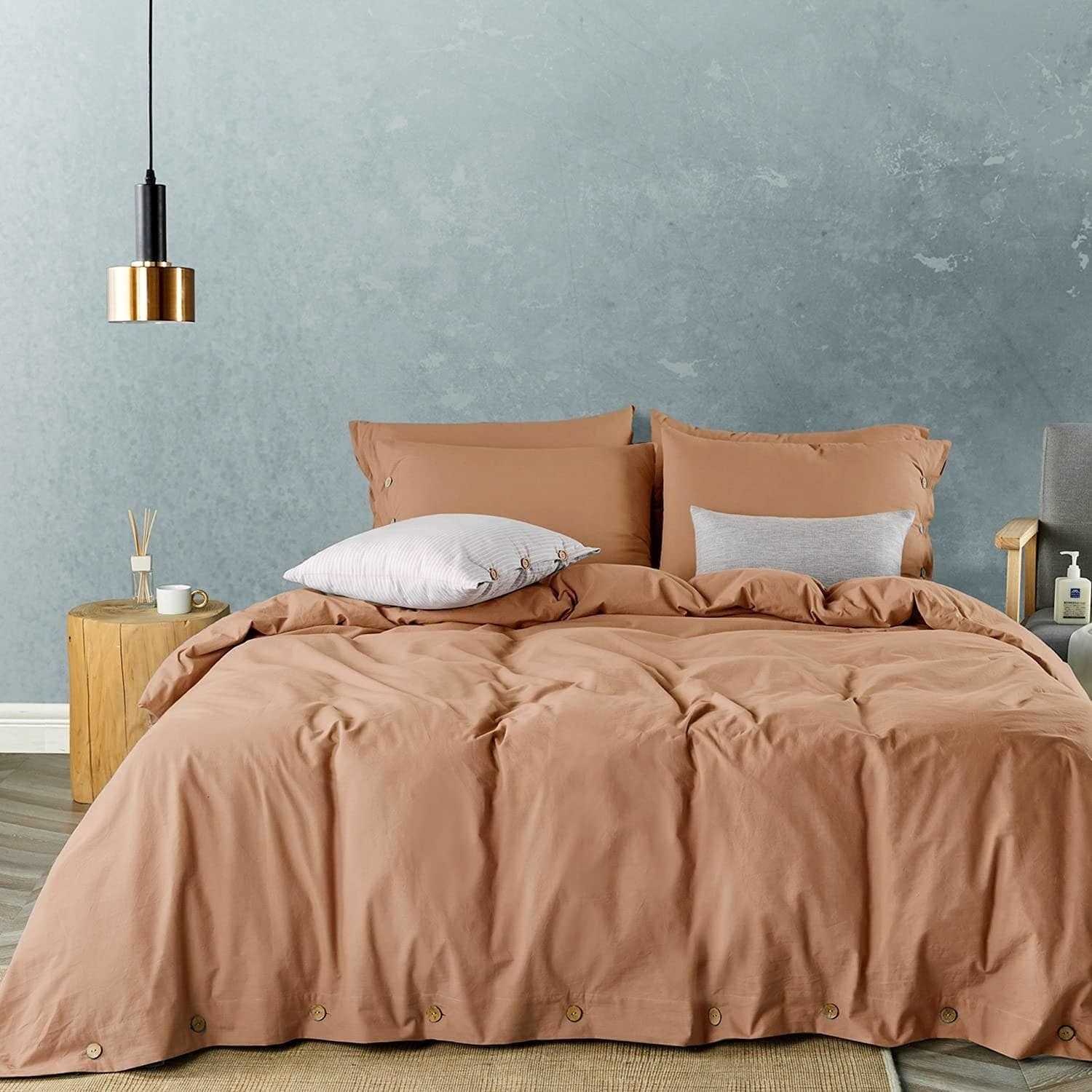 a bed with a comfy duvet on it and several pillows