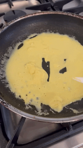 Eggs scrambling in a pan