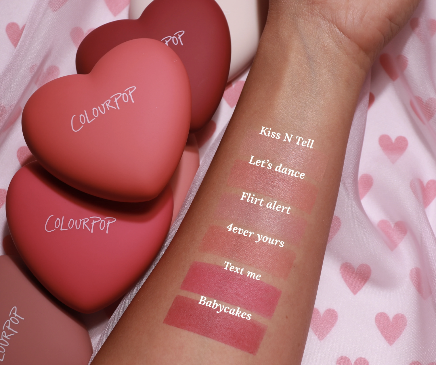 Swatches of the blushes on an arm, and the heart-shaped compacts