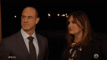 Elliot Stabler and Olivia Benson smirking at each other