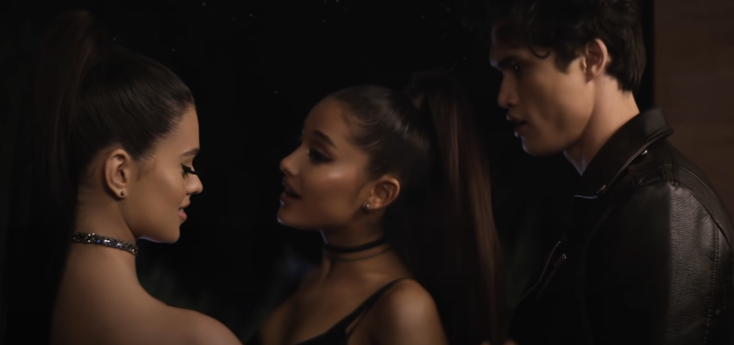 ariana with a look-alike and a male interest in the music video