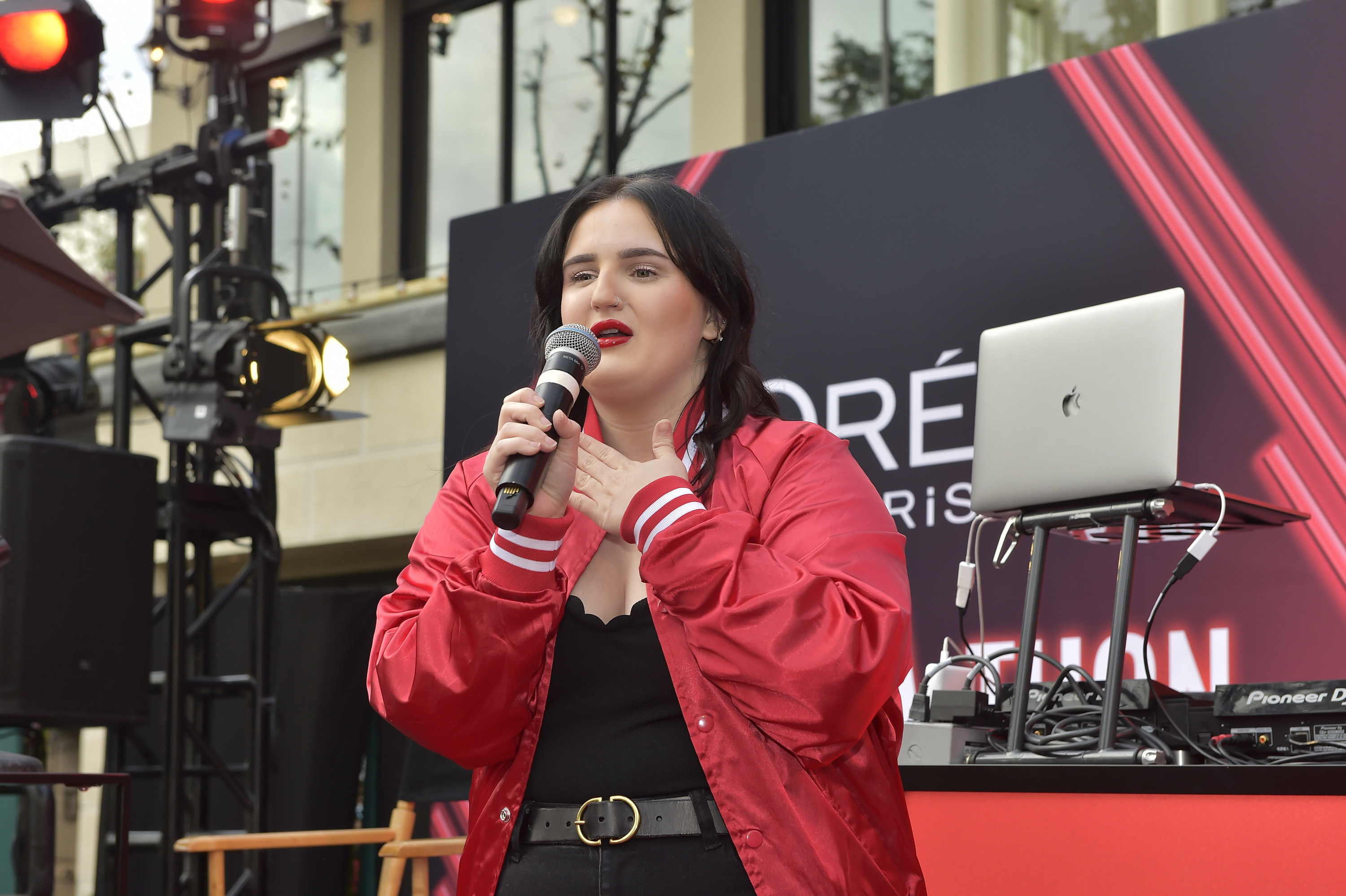 Mikayla on stage with a mic