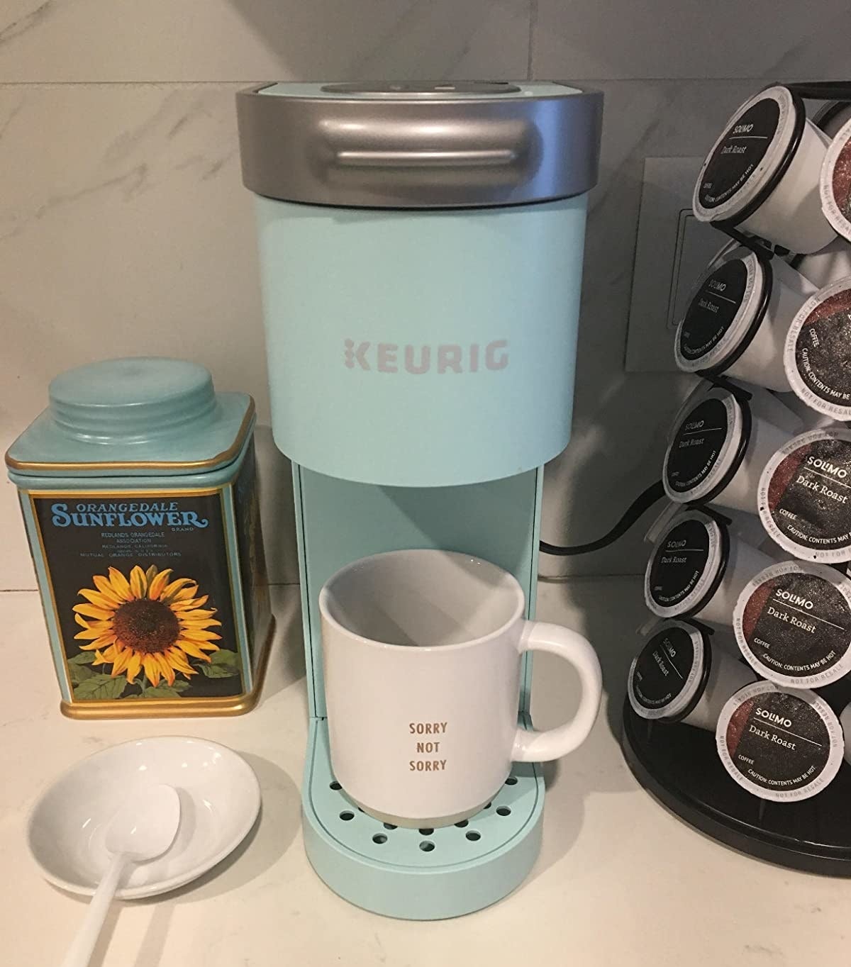 a reviewer photo of the mint colored keurig coffee maker