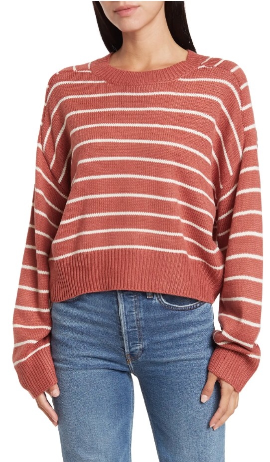 A model wearing a dusty copper/cream striped sweater