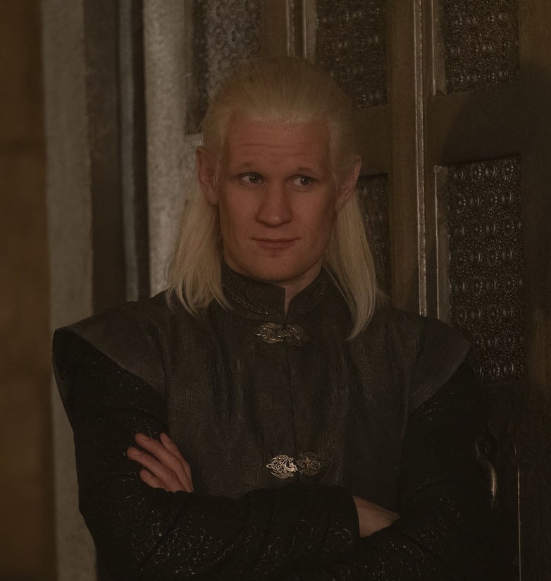 Daemon with his arms crossed looking amused