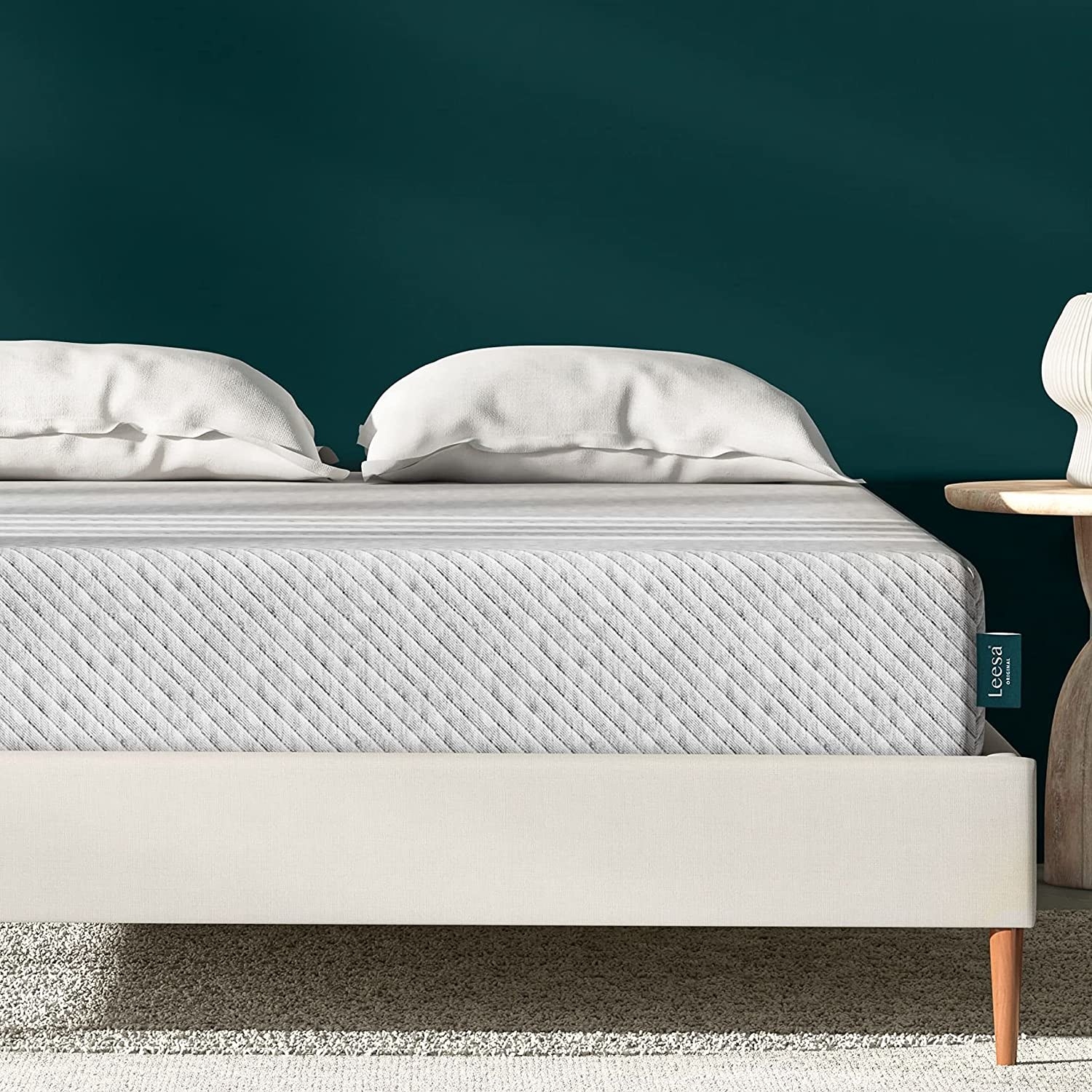 Leesa original mattress on white fabric bed frame