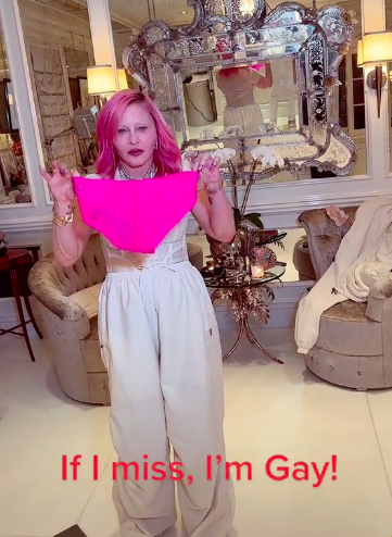 A screenshot of the TikTok with Madonna holding up the pink panties