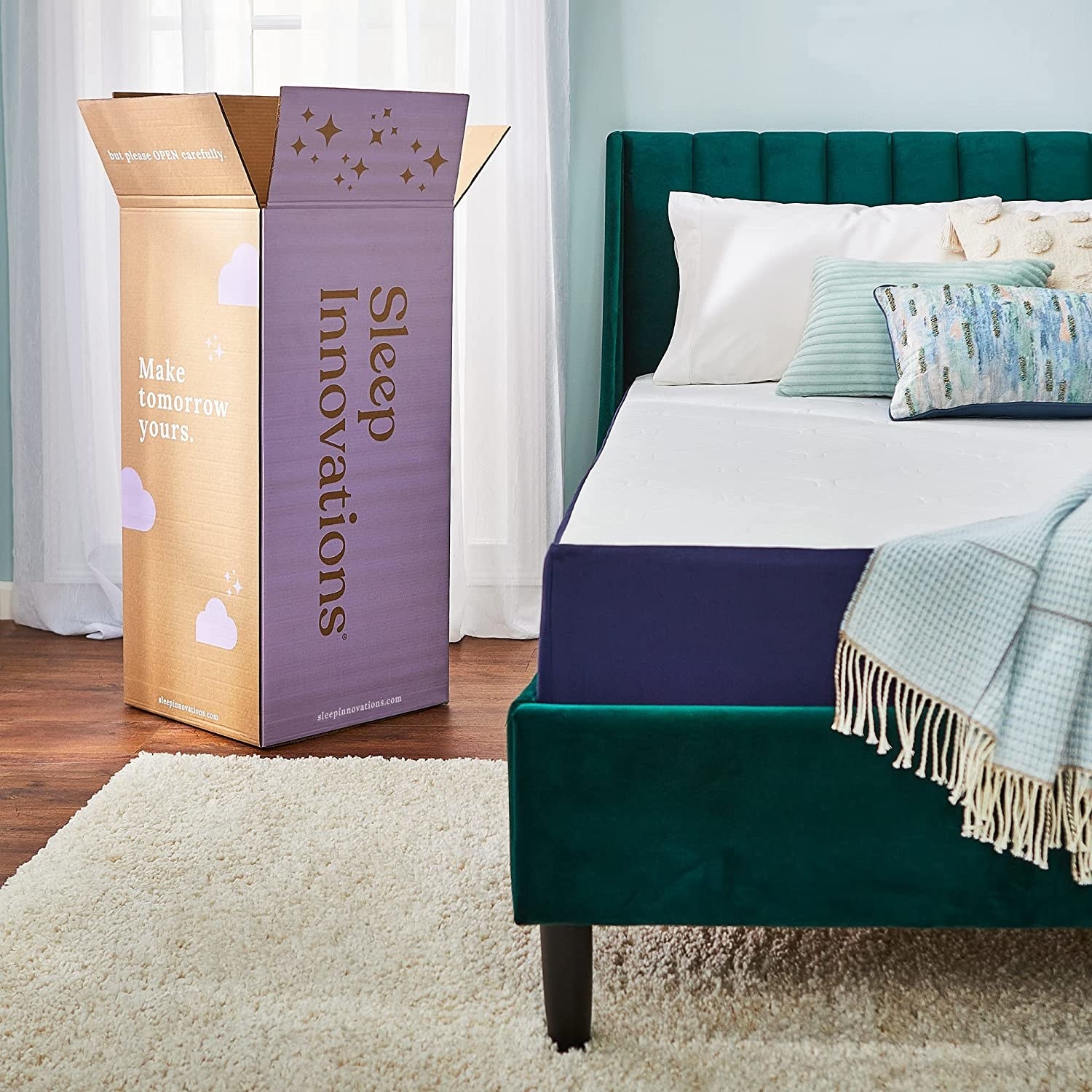 sleep innovations box next to mattress on green bed frame