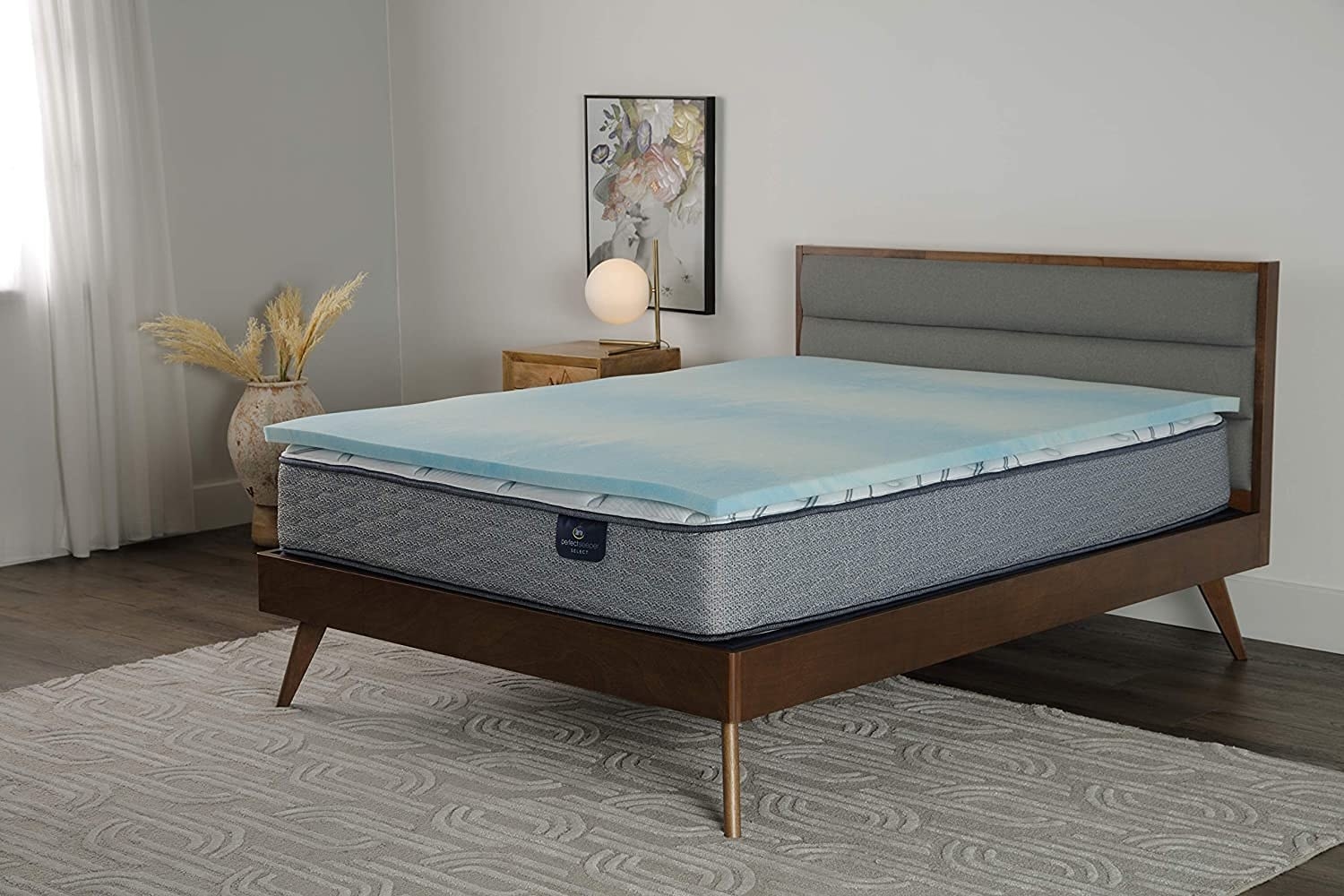serta blue mattress topper on mattress on wood bed
