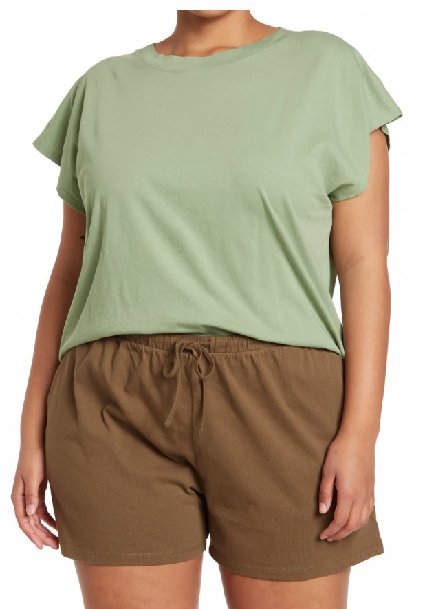 A model wearing a green short sleeve t shirt