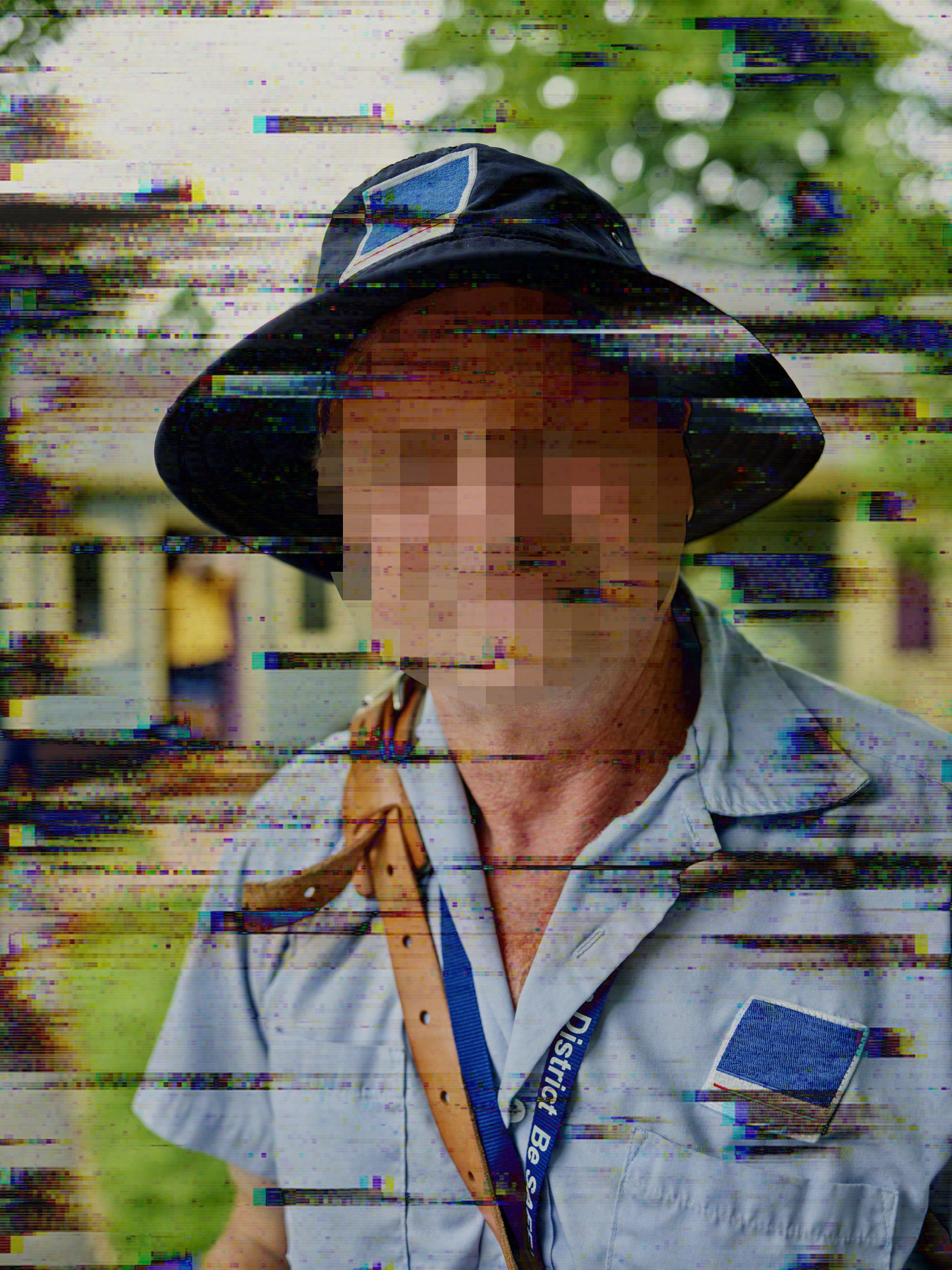 A man with his face pixelated
