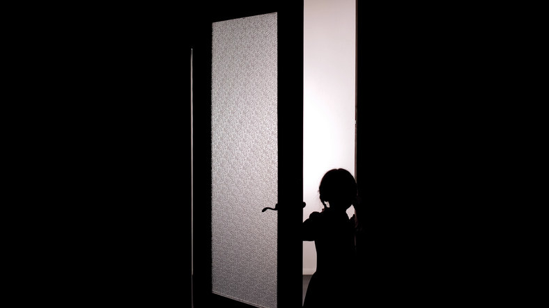 Silhouette of a child in a doorway