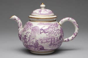 a purple and white scenic teapot
