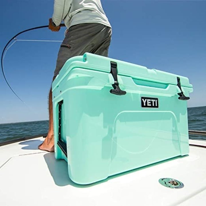 a light blue yeti cooler on a fishing boat