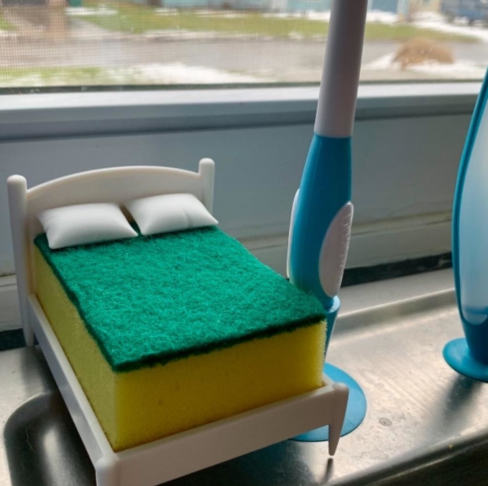 a reviewer&#x27;s bed-shaped sponge holder
