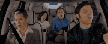 A family singing in a car.