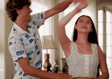 A teenage boy and girl dancing