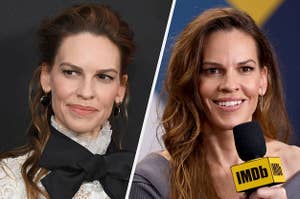 Hilary Swank wears a white lace top with a black bow and black and gold hoop earrings. She also wears a gray sweater with sparkly earrings.