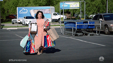 woman trips because she's carrying too many shopping bags