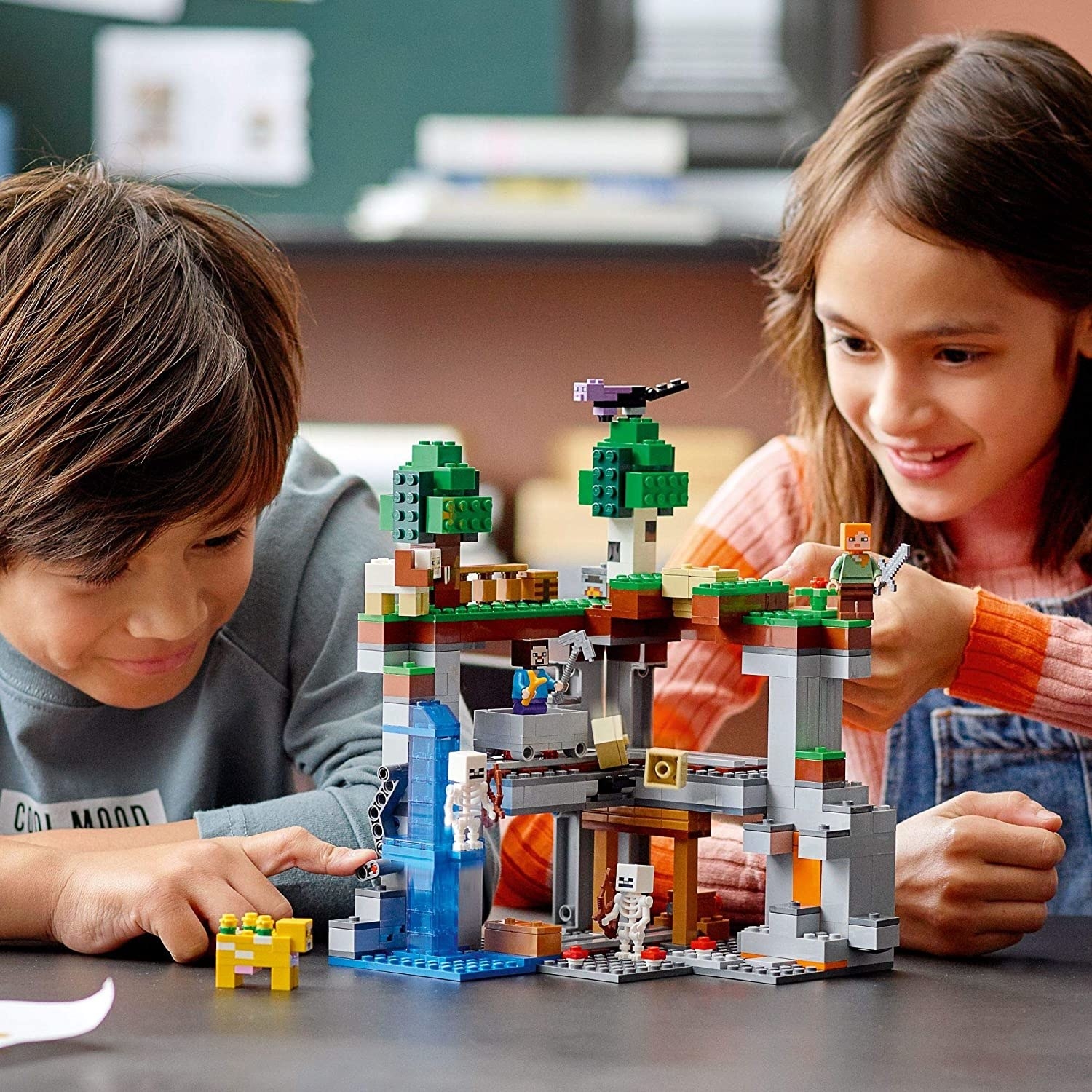 two kids playing with a lego minecraft set