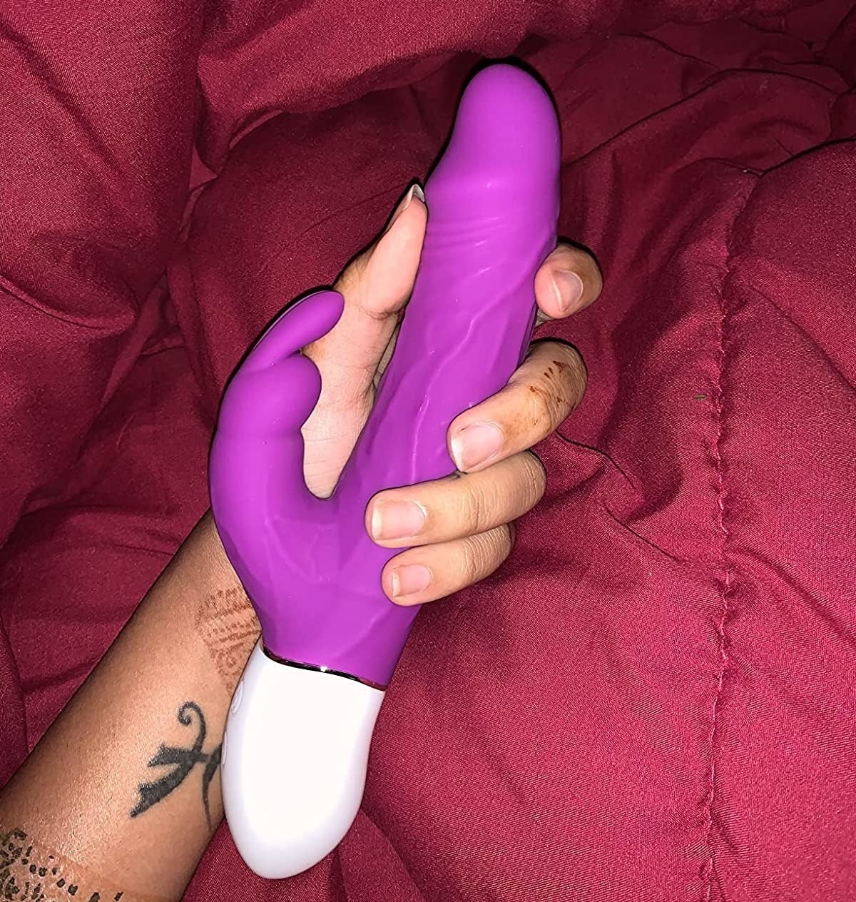 Reviewer holding purple rabbit vibrator